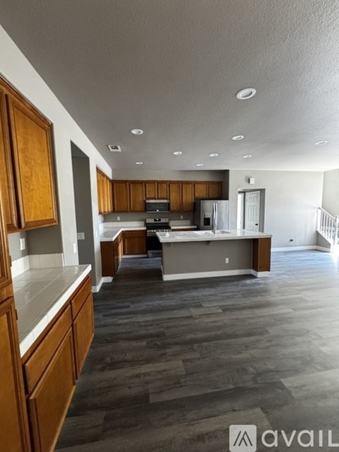 A spacious kitchen with wooden cabinets and a large island.