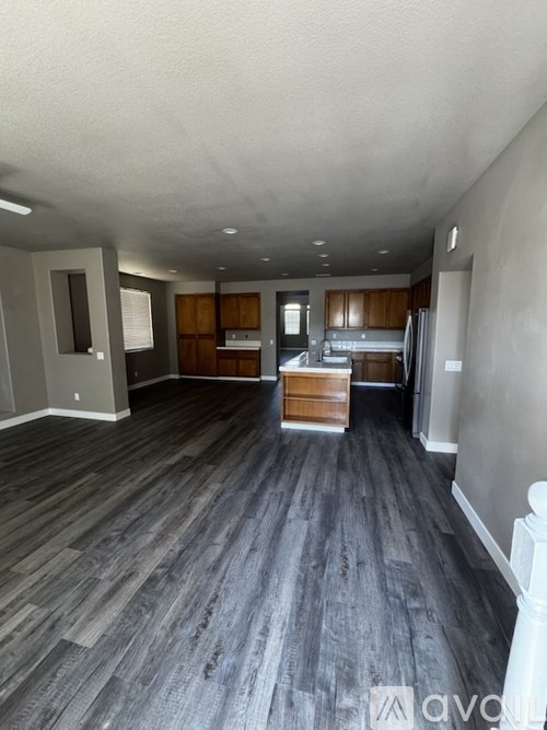 A room with wooden flooring and a white ceiling.
