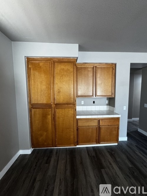 A kitchen with wooden cabinets and a countertop.