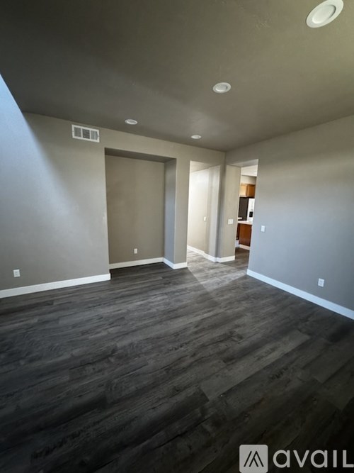 A room with grey walls and wooden flooring.