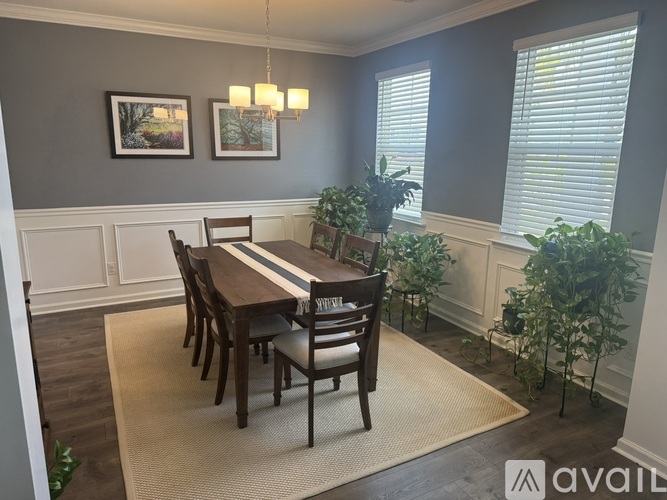A dining room with a wooden table and chairs.
