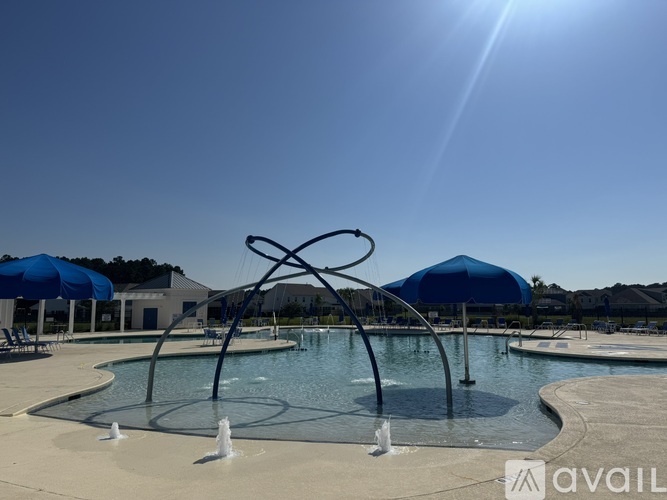 A sunny day at the outdoor pool with a large fountain in the center.