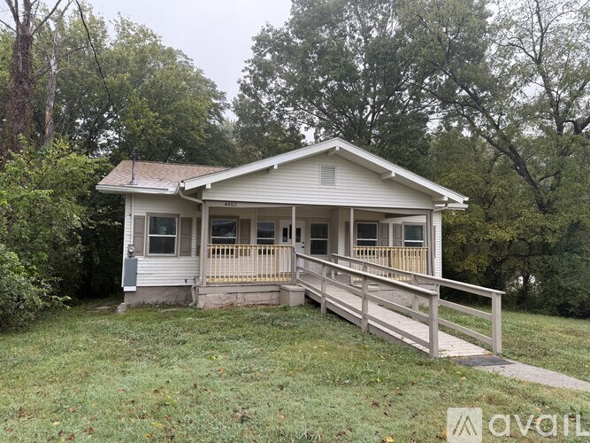 A house with a porch and a deck is for sale.