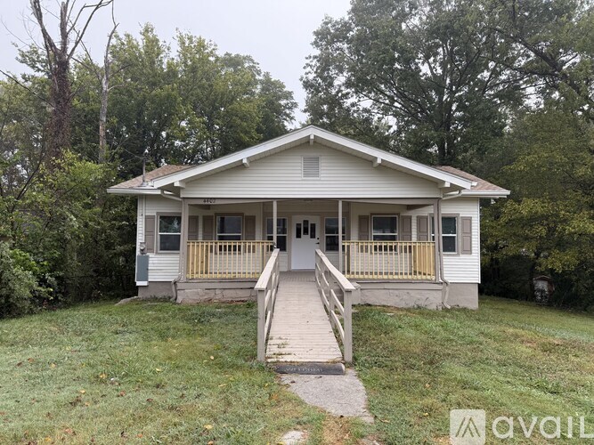 A house with a porch and a front yard.