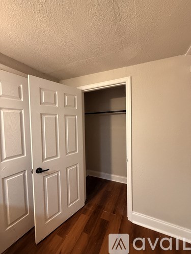 A room with a wood floor and a window.