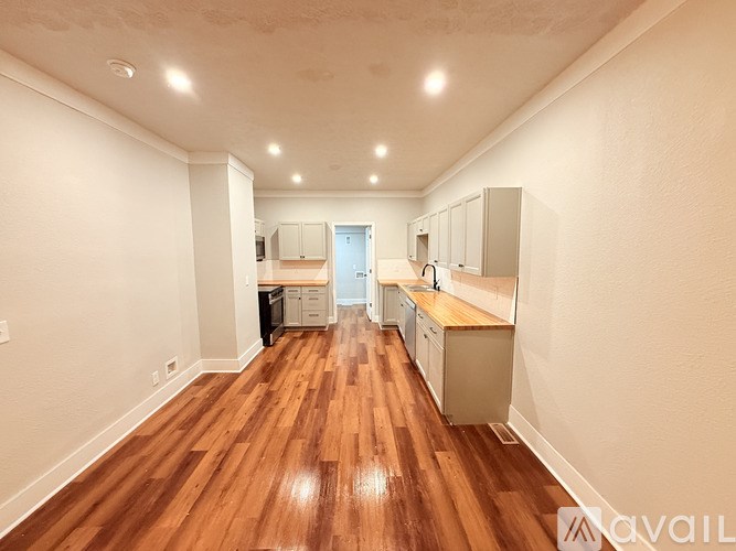 A room with wooden floors and white walls.