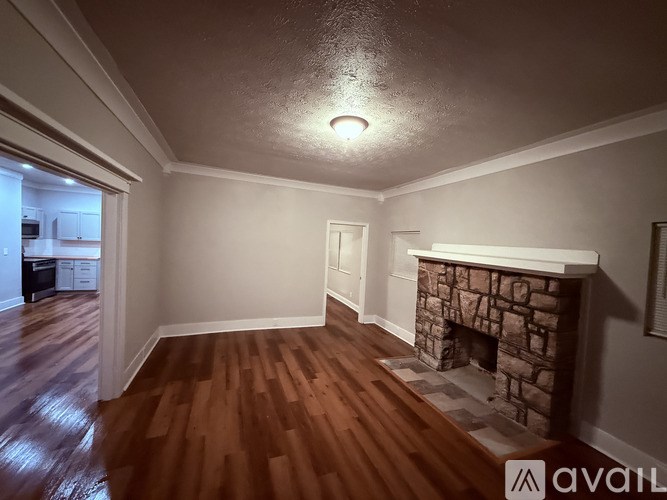 A bathroom with a toilet, sink, and shower.