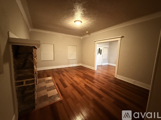 A white toilet sits next to a white bathtub in a small bathroom.
