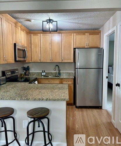 A kitchen with wooden cabinets and a granite countertop.