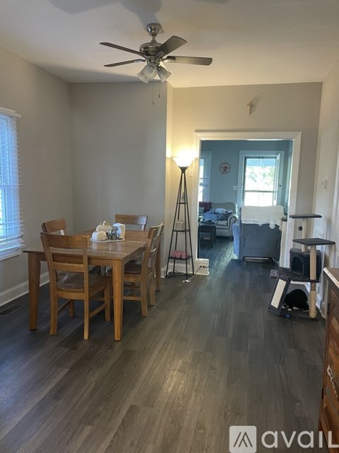A dining room with a table and chairs.