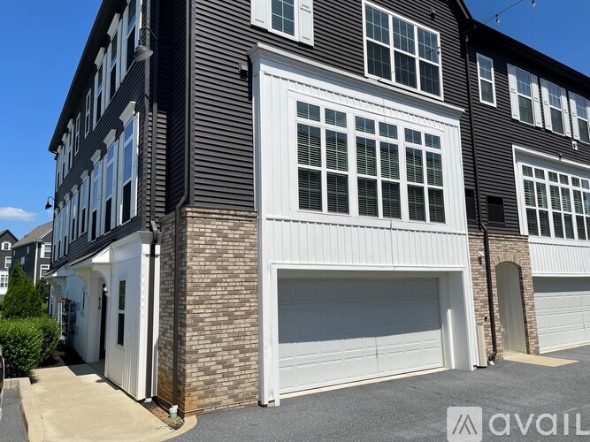 A modern two-story house with a garage on the ground floor.