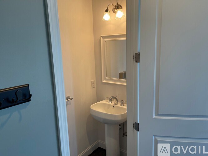 A bathroom with a sink and mirror.
