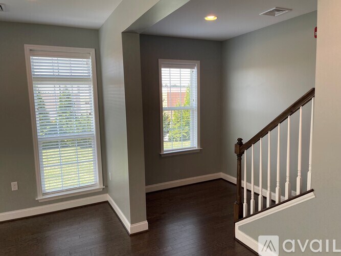A room with a window and a staircase.