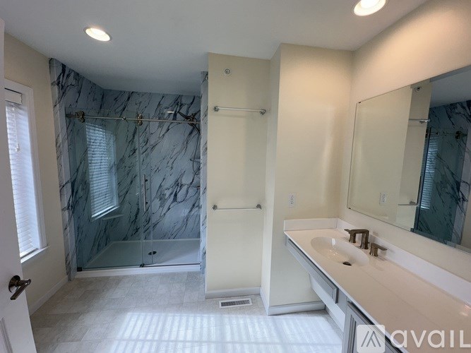 A room with a carpeted floor and a white door.