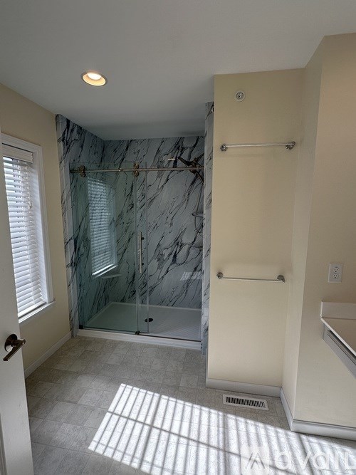 A room with a carpeted floor and white closet doors.