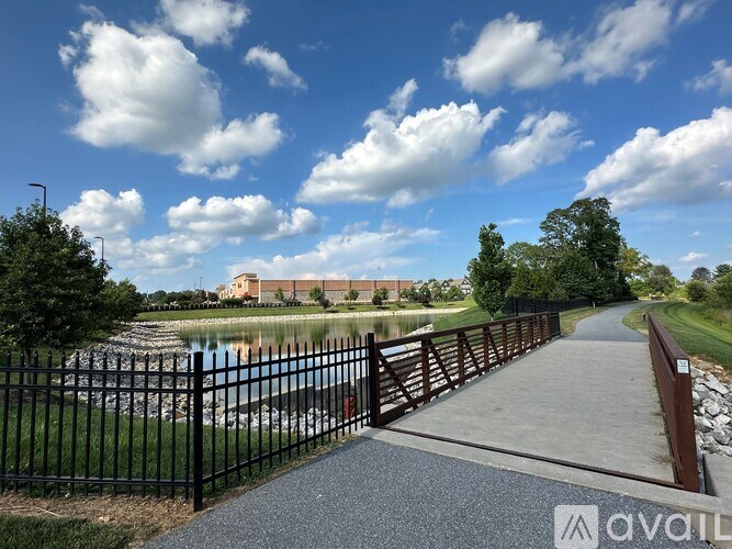 A walkway with a metal railing leads to a building.