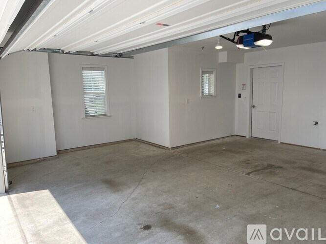 A park with a pond, a fence and a building in the background.
