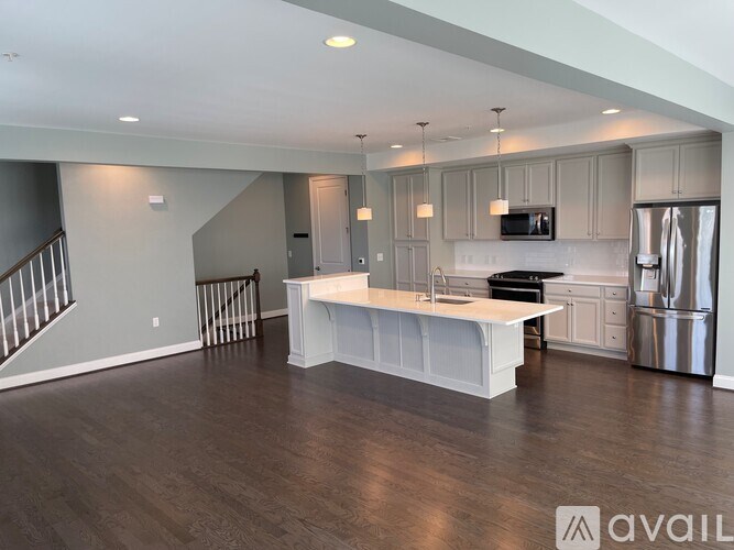 A spacious kitchen with a refrigerator, microwave, and oven.