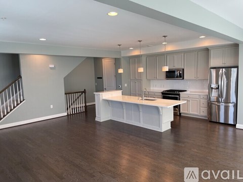 A spacious kitchen with a refrigerator, microwave, and oven.