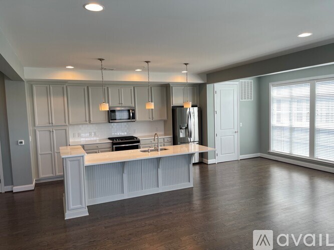 A modern kitchen with a wooden island and stainless steel appliances.
