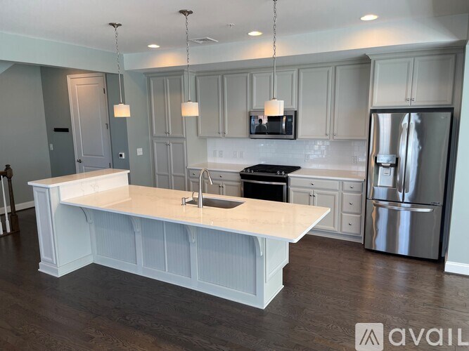 A kitchen with a white island in the middle of it.