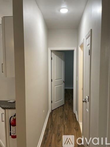 A hallway with a fire extinguisher on the wall.