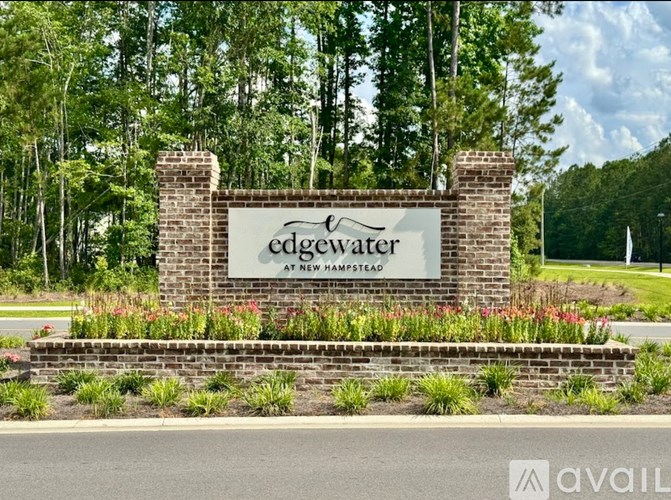 A sign for Edgewater at New Hampshire is displayed in front of a green landscape.