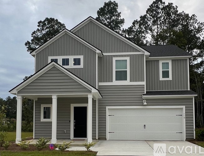 A white door is in the middle of a room with a staircase.