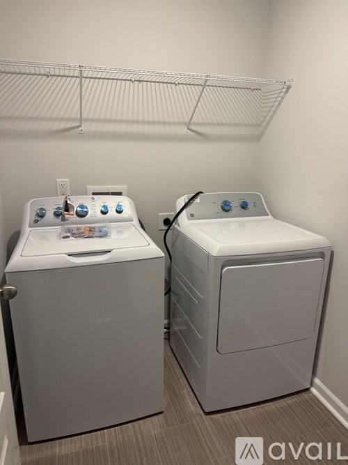 A house with a grey and white exterior is shown with the Avail logo in the bottom right corner.