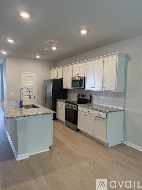 A room with a ceiling fan and two windows.