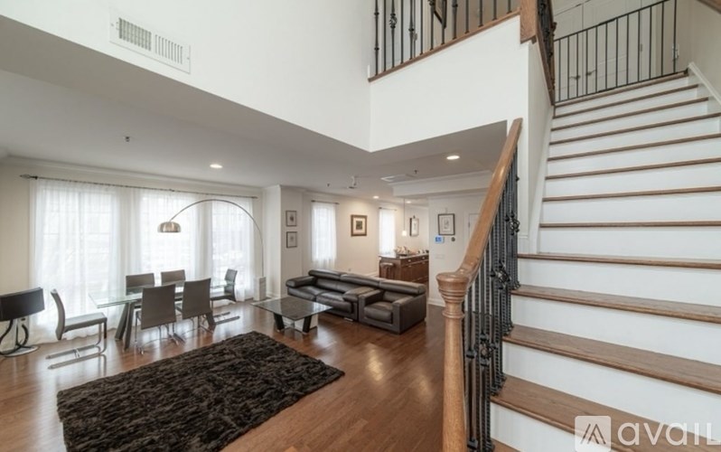 A living room with a staircase leading to the upper floor.