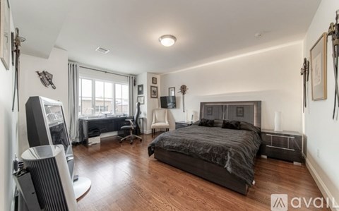 A bedroom with a large bed and a workout area.