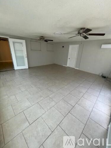A room with tile flooring and a ceiling fan.
