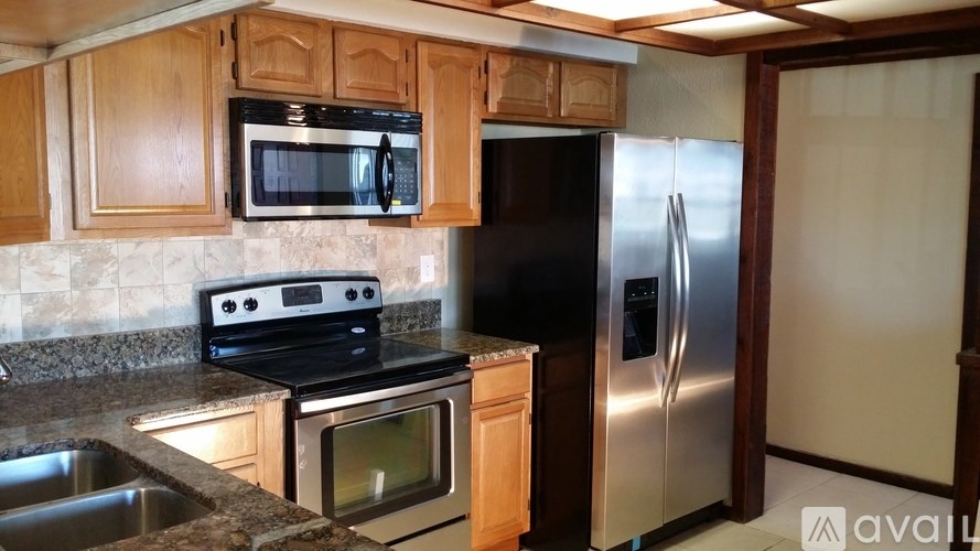 A kitchen with a black oven and a black microwave above it.