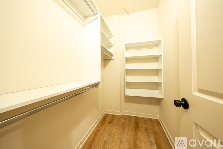 A white door with a black handle is on the right side of the image.