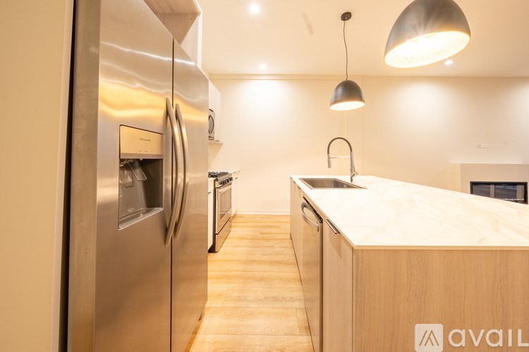 A modern kitchen with wooden countertops and stainless steel appliances.