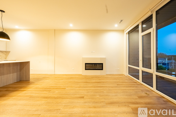 A modern living room with a fireplace and sliding glass doors.