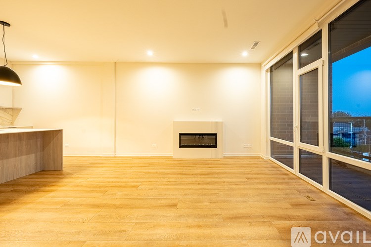 A modern living room with a fireplace and sliding glass doors.