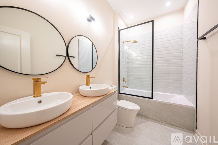 A bathroom with a white sink and a toilet.