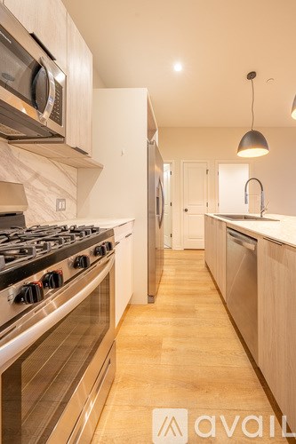 A modern kitchen with a stove top oven and microwave.