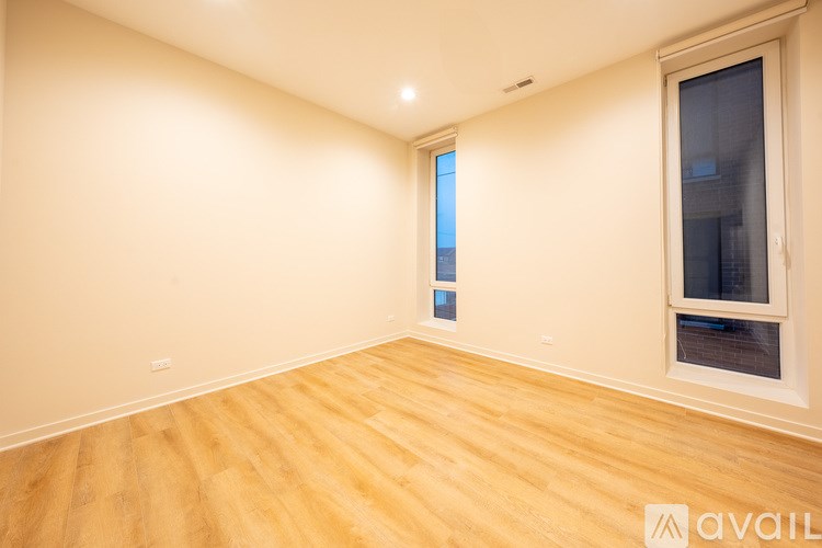 A room with wooden flooring and a window.