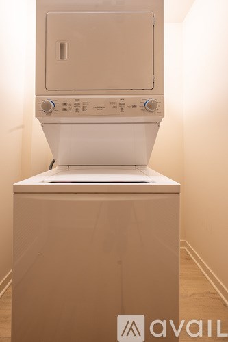 A white dryer is sitting on top of a white washing machine.