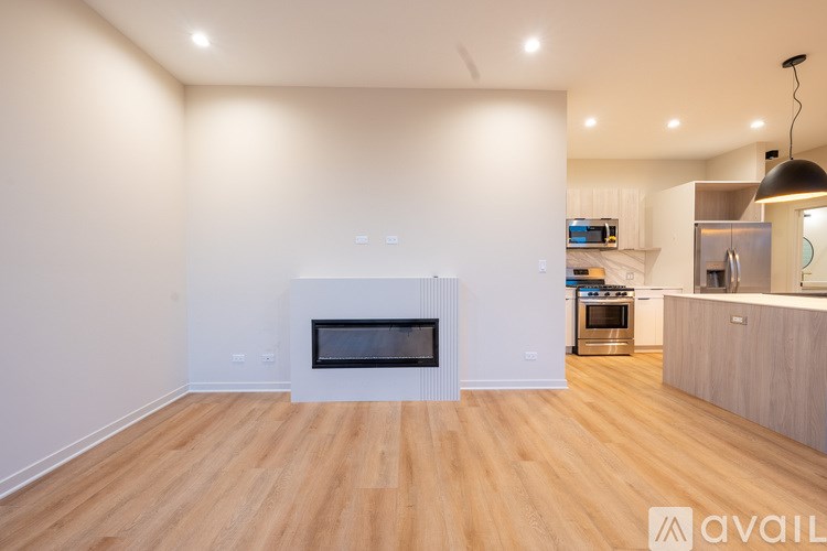 A modern kitchen with a fireplace in the middle of the room.