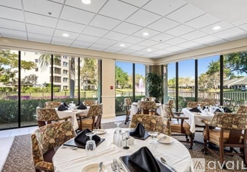 A dining room with tables set for a meal.