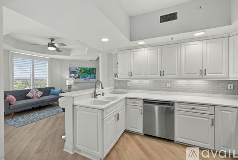 A kitchen with white cabinets and a stainless steel dishwasher.