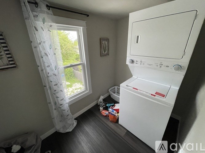 A small laundry room with a washer and dryer.