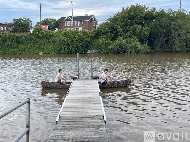 Two people are sitting in canoes on a lake.