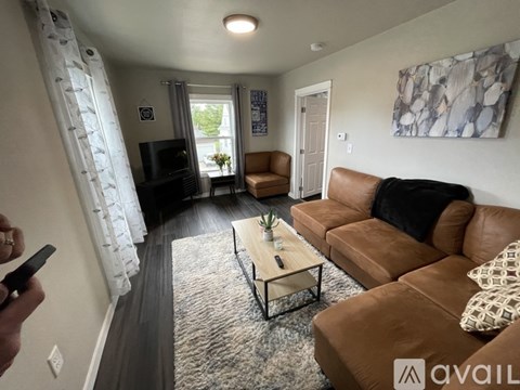 A living room with a brown couch and a coffee table.