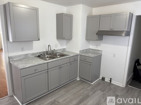 A kitchen with a sink and cabinets.