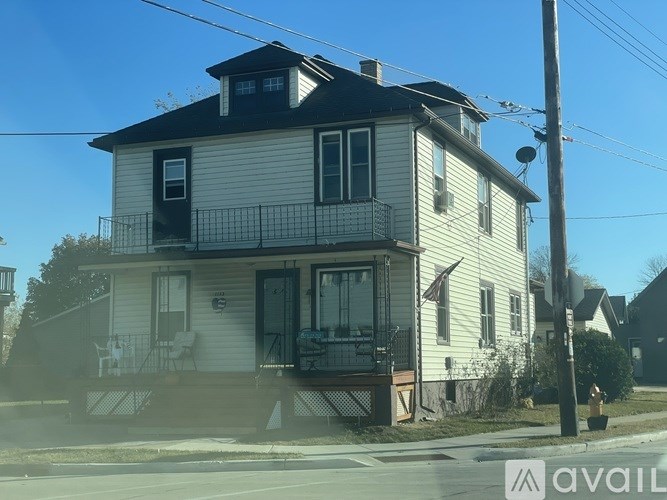 A two-story house with a balcony on the second floor.